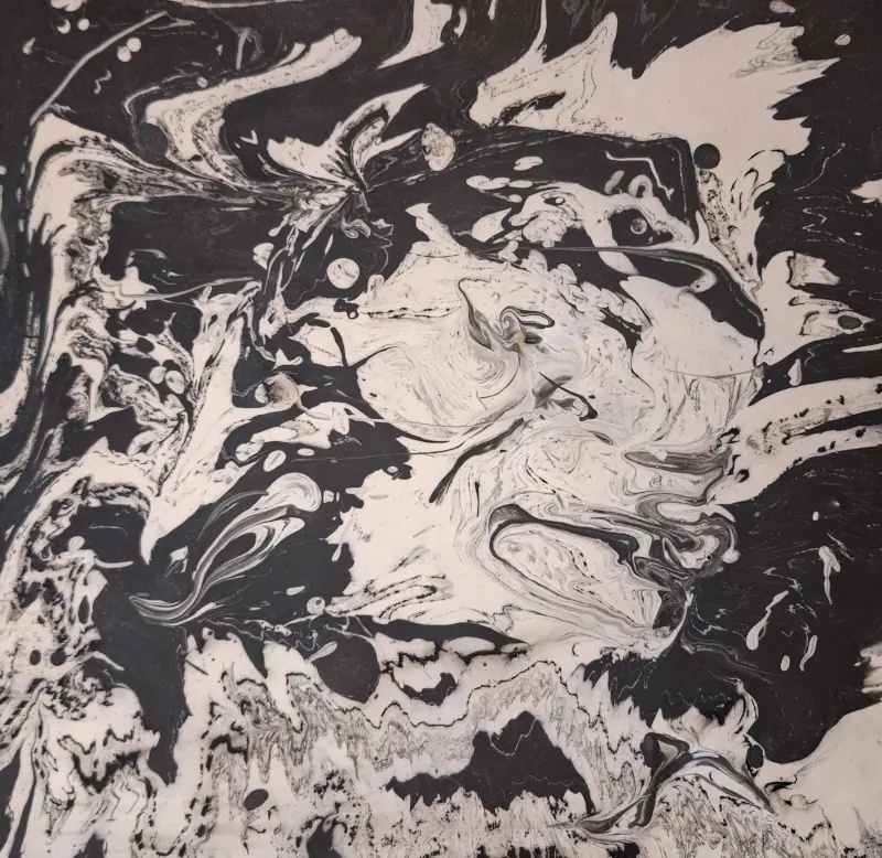Detail of the base of a chessboard, in jesmonite, with ghostly looking figures, if you use your imagination
