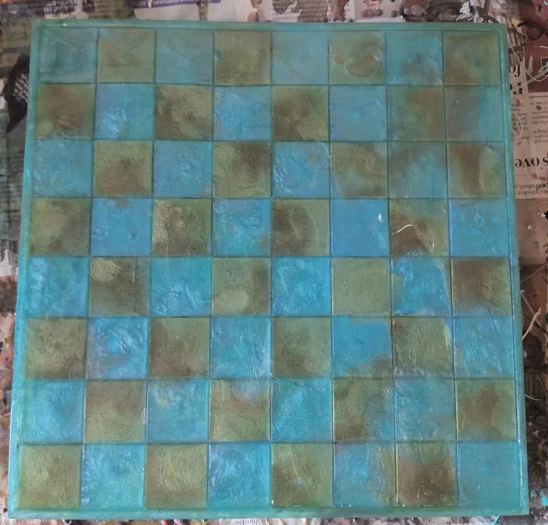 A epoxy resin chessboard in camouflage green and navy teal