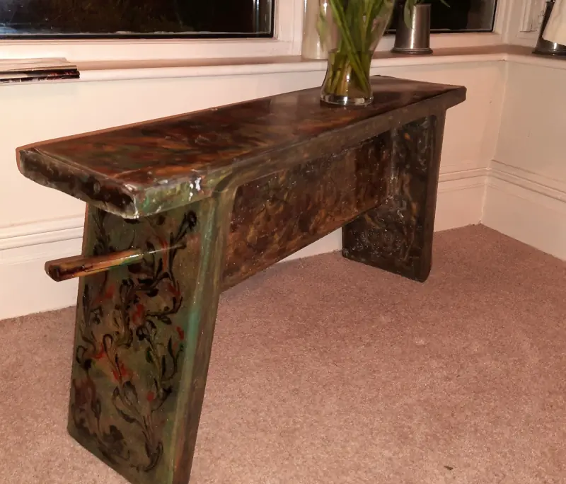 A wooden bench, coated with decorative patterned epoxy resin