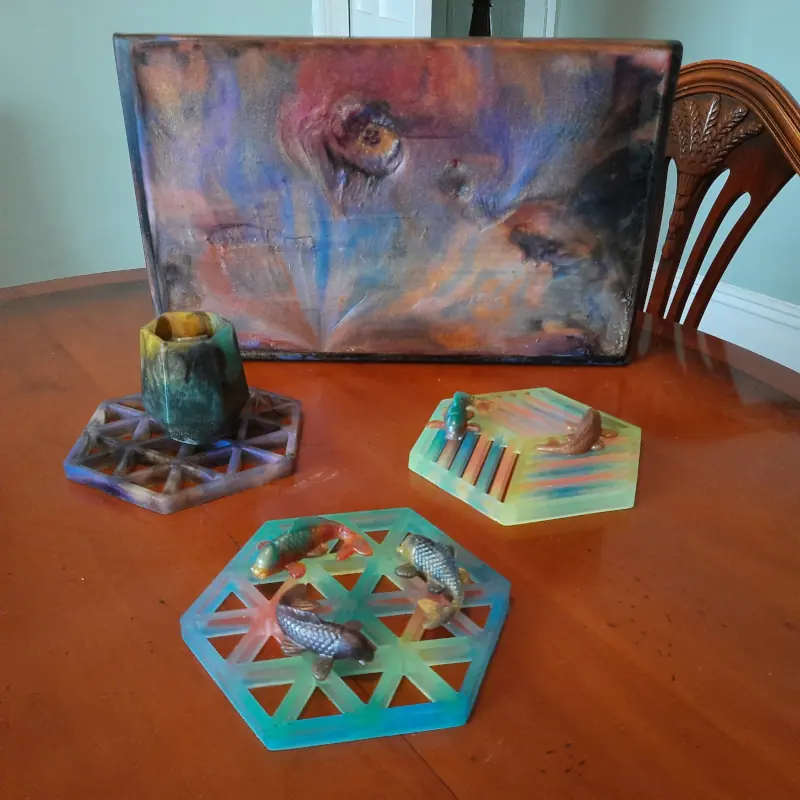 A few coasters, jars, fish and an abstract piece on wood, all made with epoxy resin