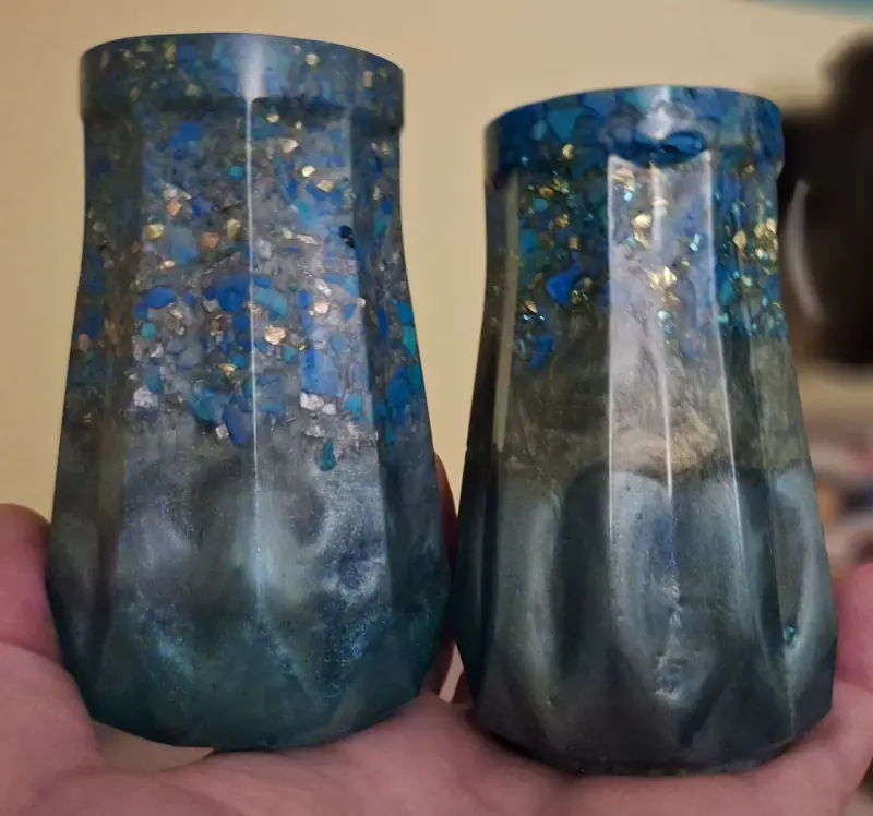 Two epoxy resin jars, containing blue and green jesmonite fragments