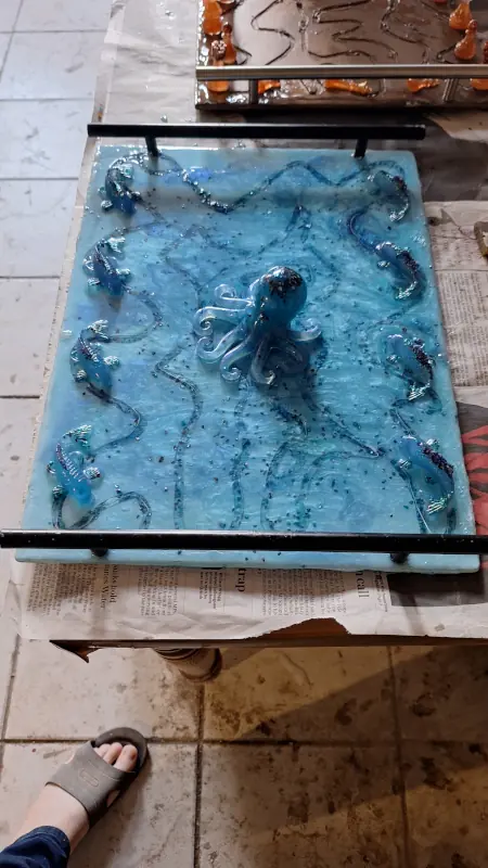 An epoxy resin tray, in ocean blue, with decorative octopus and fish